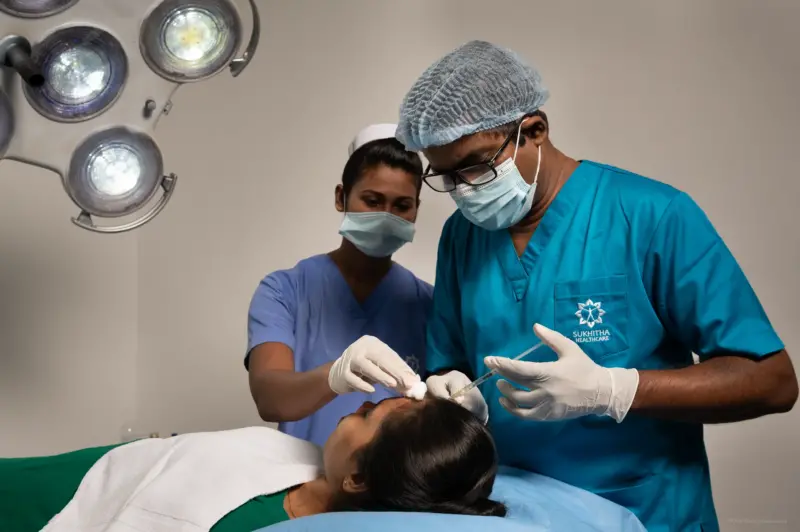 A Doctor assisted by a Nurse performing a beauty treatment on a patient - Sri Lanka