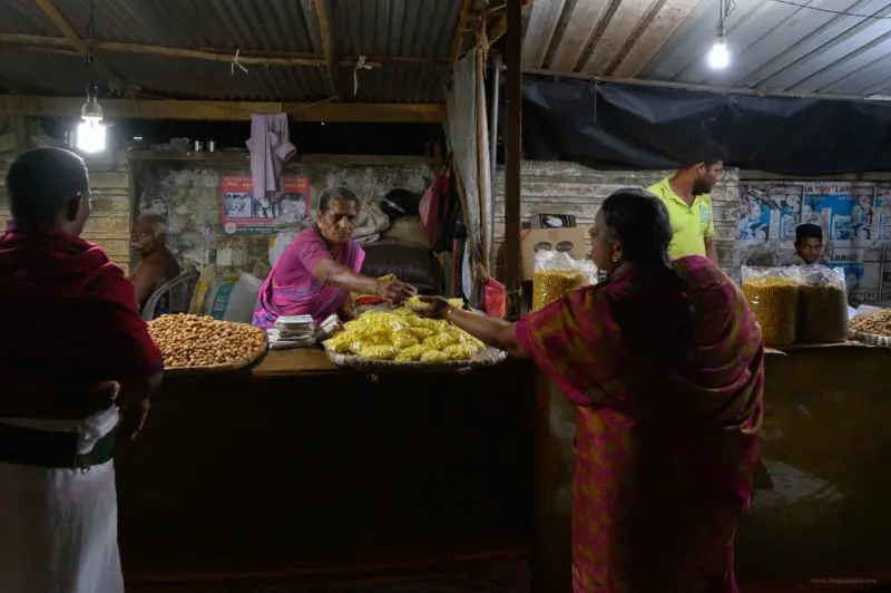 A woman receiving change from a street vendor - Jaffna, Sri Lanka