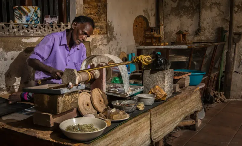 A Lapidary demonstrating the usage of traditional lapidary tools - Galle, Sri Lanka